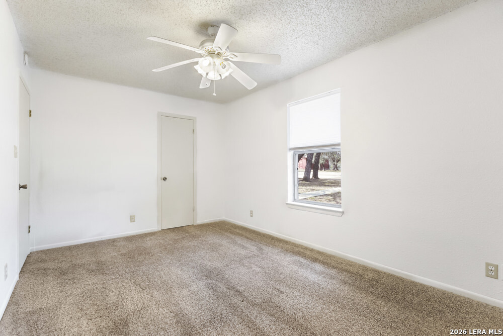 292 Montague Drive Bandera, TX 78003 - Photo 14 of 24 an empty room with windows and fan