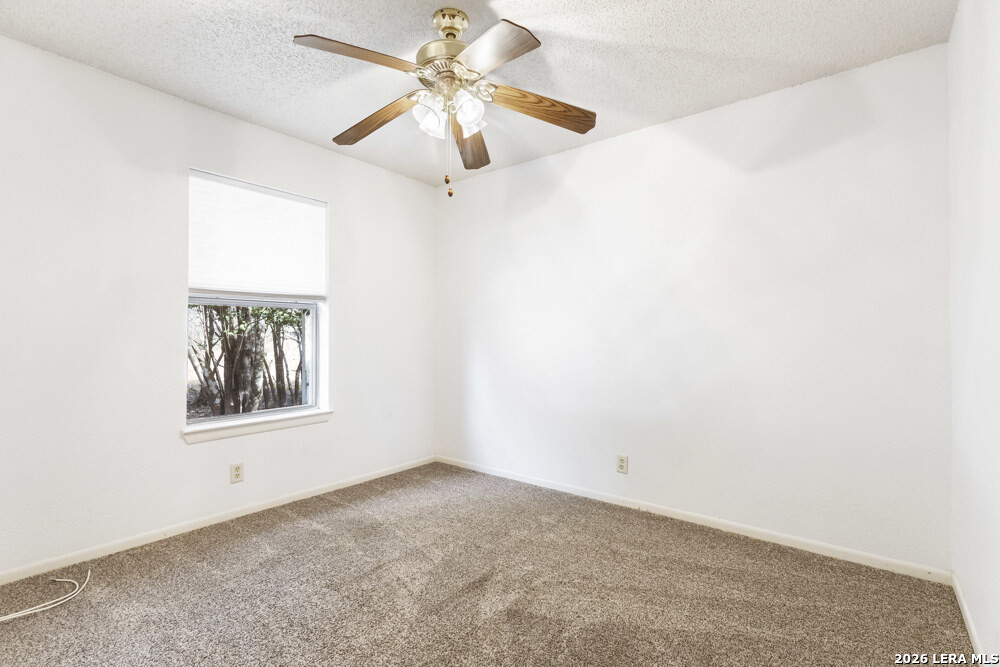 292 Montague Drive Bandera, TX 78003 - Photo 16 of 24 an empty room with a window and a fan