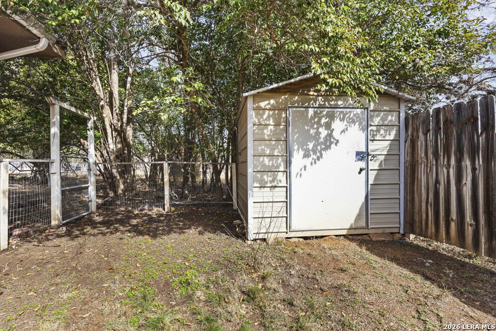 292 Montague Drive Bandera, TX 78003 - Photo 22 of 24 a view of a wooden door with a tree