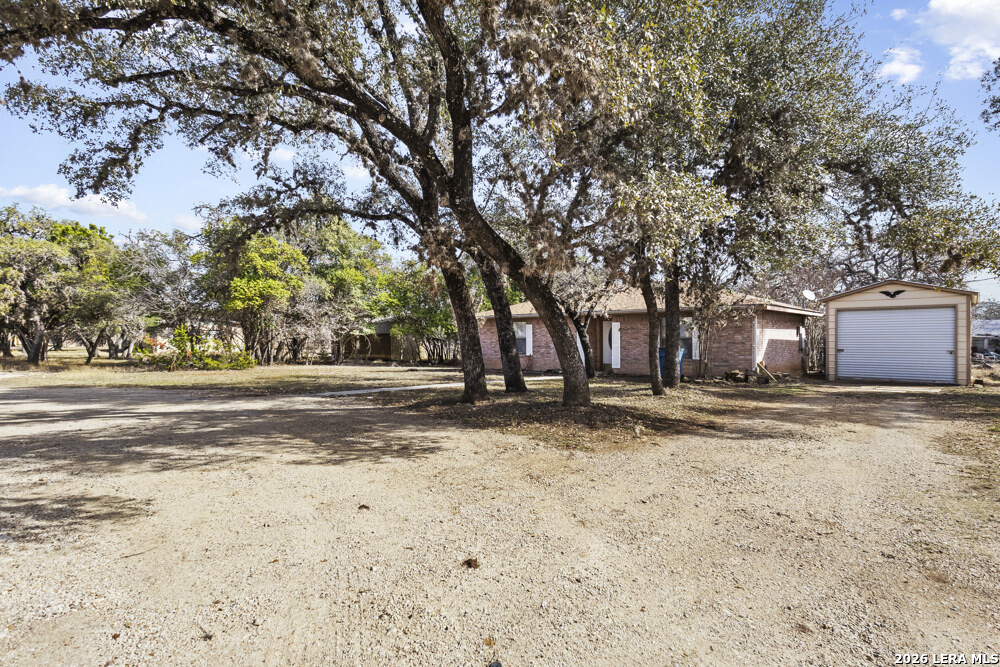 292 Montague Drive Bandera, TX 78003 - Photo 3 of 24 a view of a yard with a large tree