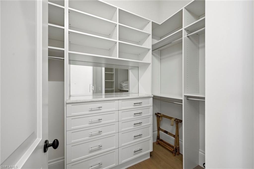 215 3rd Avenue North Naples, FL 34102 - Photo 32 of 47 Walk in closet with dark wood finished floors