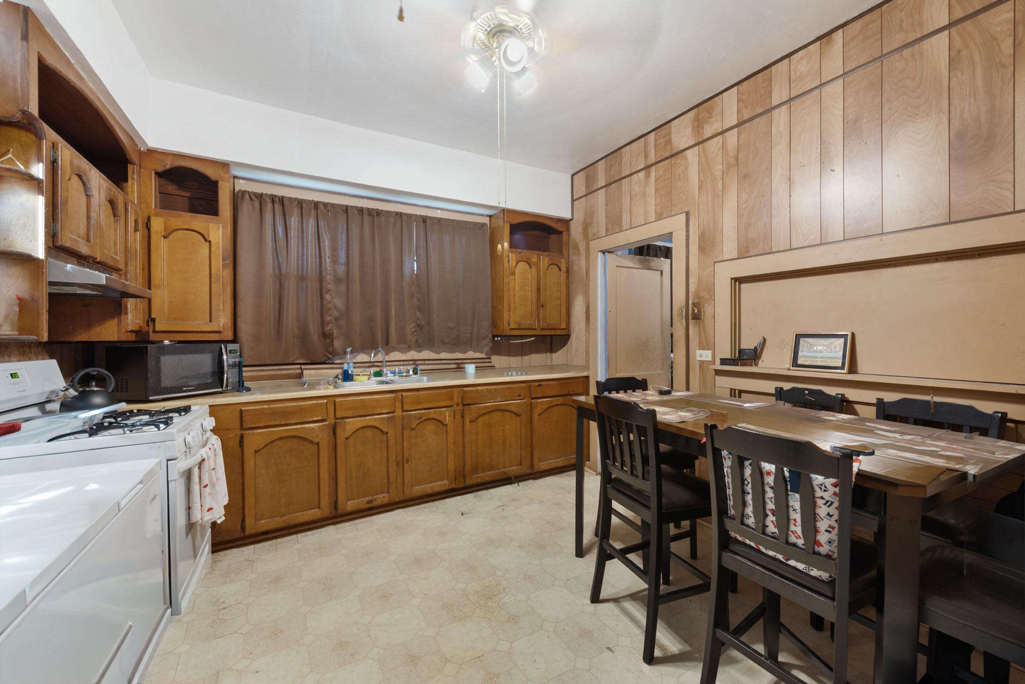 917 Trinity Street Lockhart, TX 78644 - Photo 8 of 13 a kitchen with stainless steel appliances granite countertop a stove a sink dishwasher and cabinets with wooden chairs