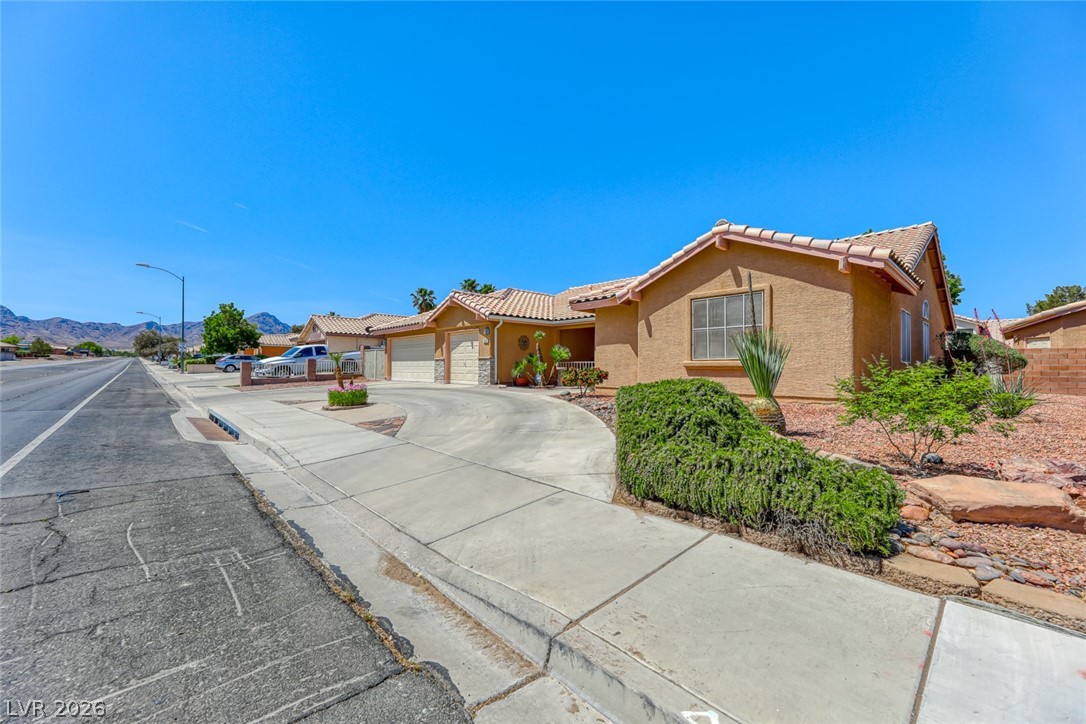 2001 Appaloosa Road Henderson, NV 89002 - Photo 42 of 44 This charming residence features a well-maintained exterior and a paved driveway, perfect for comfortable living.