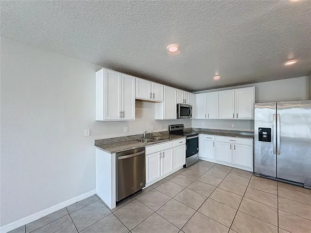a kitchen with a stove top oven sink and cabinets