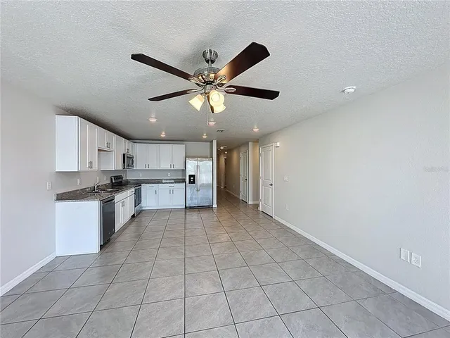 a kitchen with a cabinets and white appliances