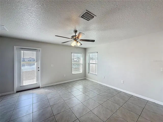 a view of a livingroom with a ceiling fan and window