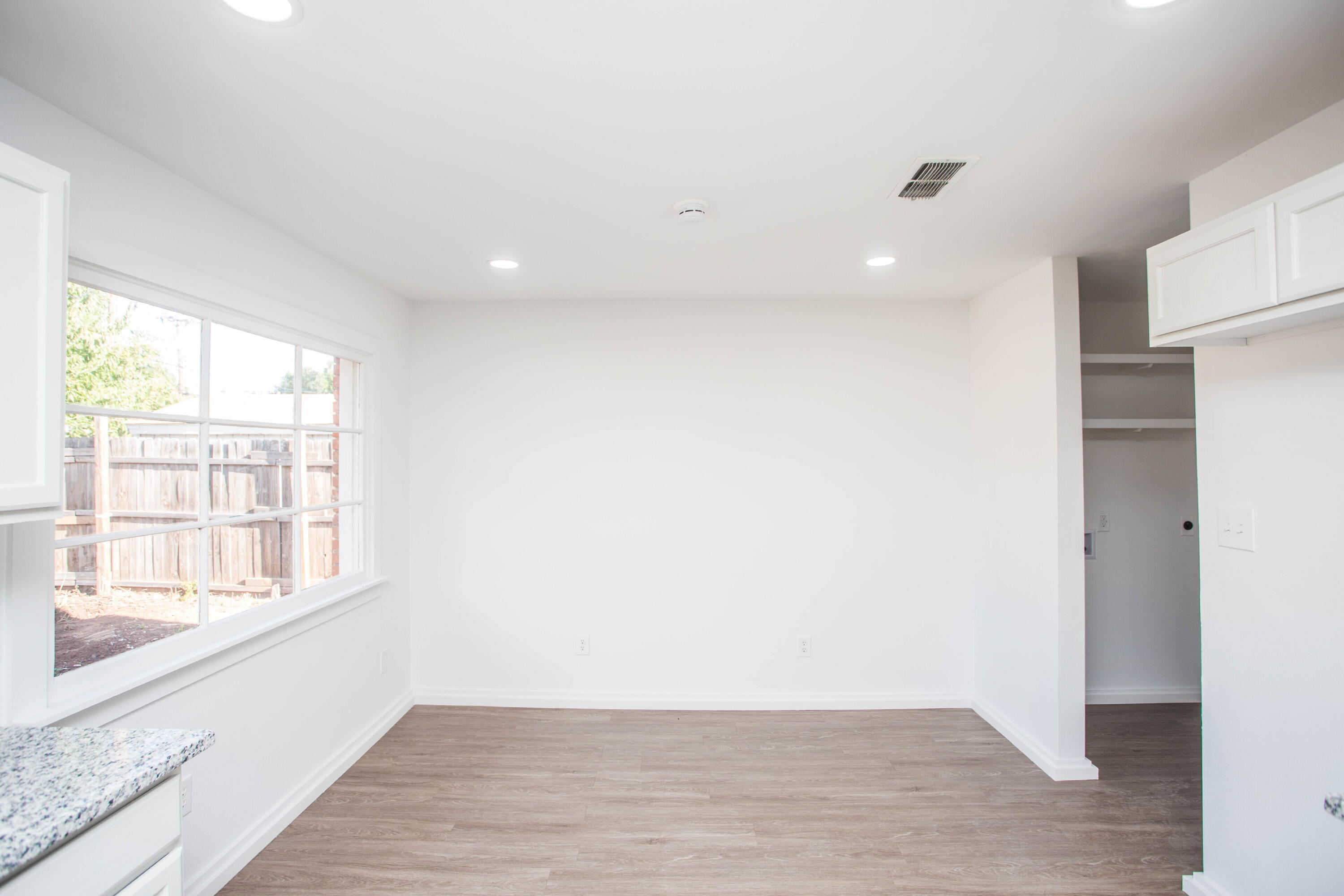 6004 Vernon Avenue Lubbock, TX 79412 - Photo 11 of 34 a view of an empty room with wooden floor and a window