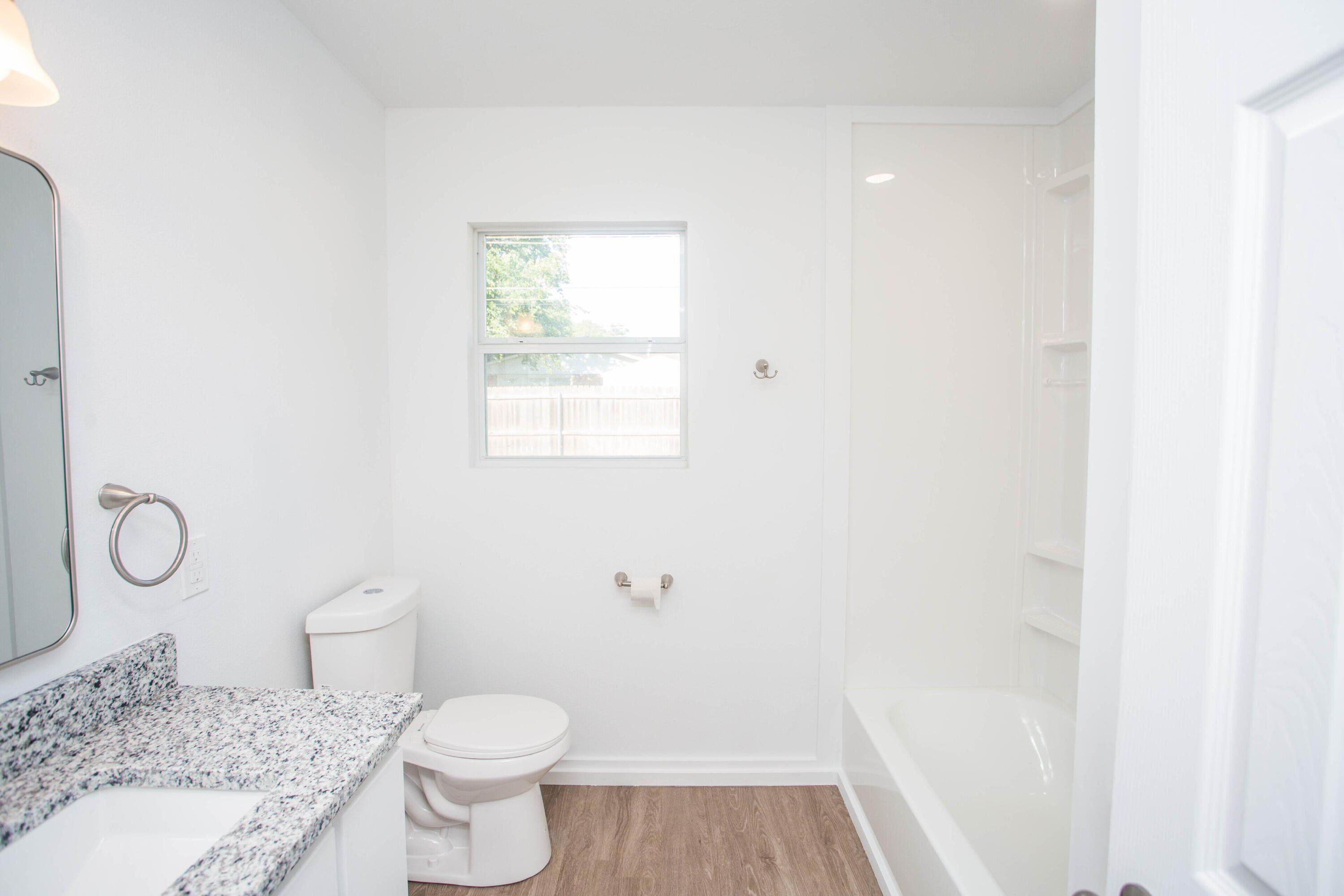 6004 Vernon Avenue Lubbock, TX 79412 - Photo 20 of 34 a bathroom with a granite countertop toilet and a sink