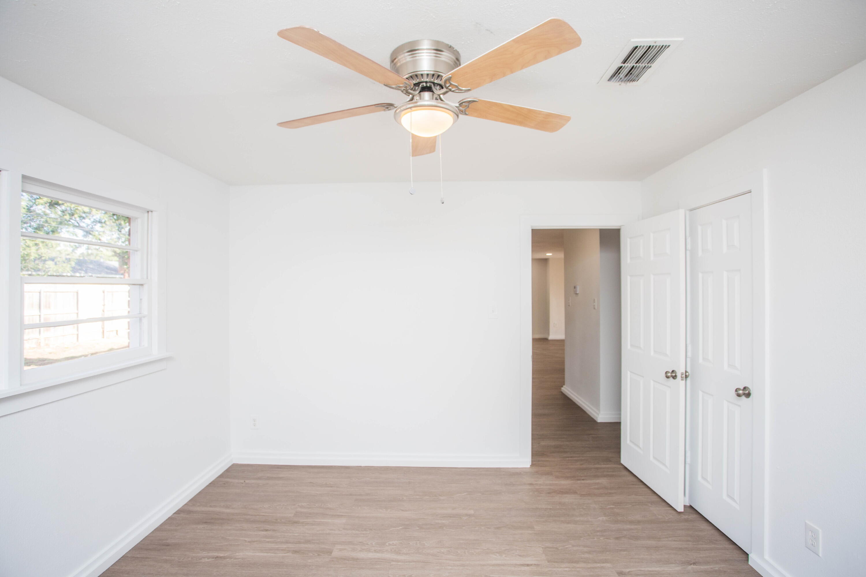 6004 Vernon Avenue Lubbock, TX 79412 - Photo 25 of 34 wooden floor in an empty room with a window