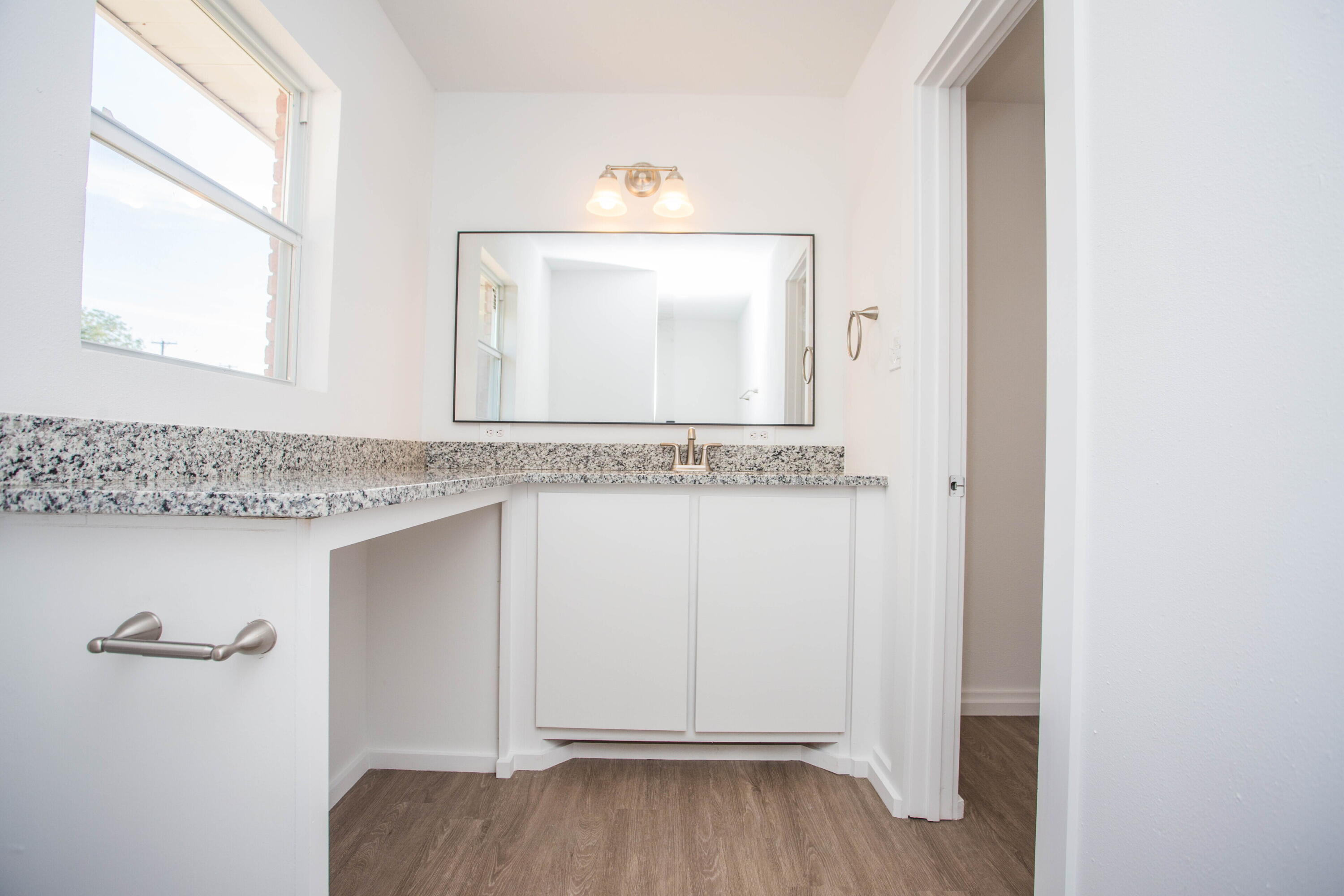 6004 Vernon Avenue Lubbock, TX 79412 - Photo 26 of 34 a bathroom with a granite countertop sink and a mirror