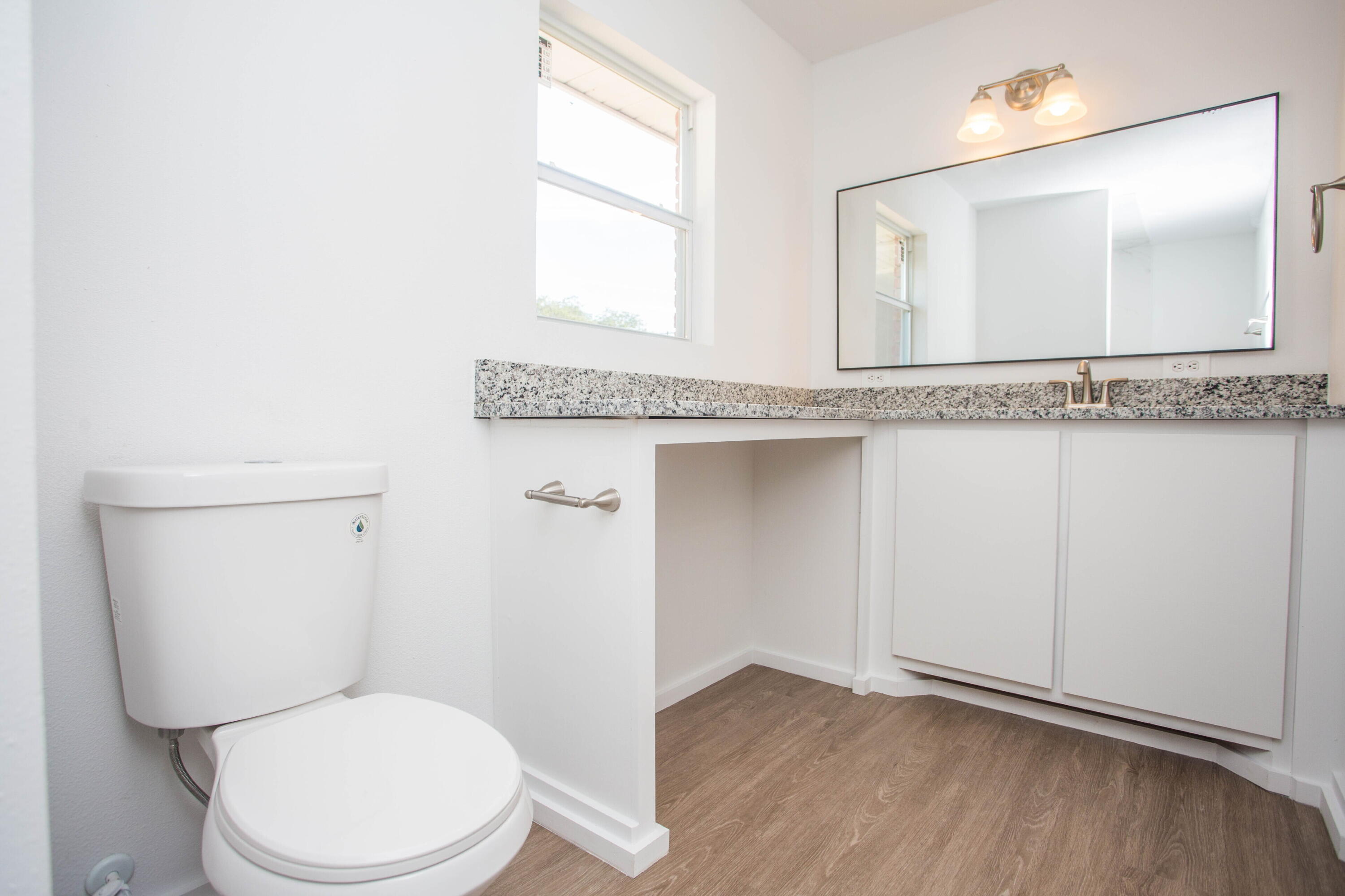 6004 Vernon Avenue Lubbock, TX 79412 - Photo 28 of 34 a bathroom with a toilet a sink and mirror