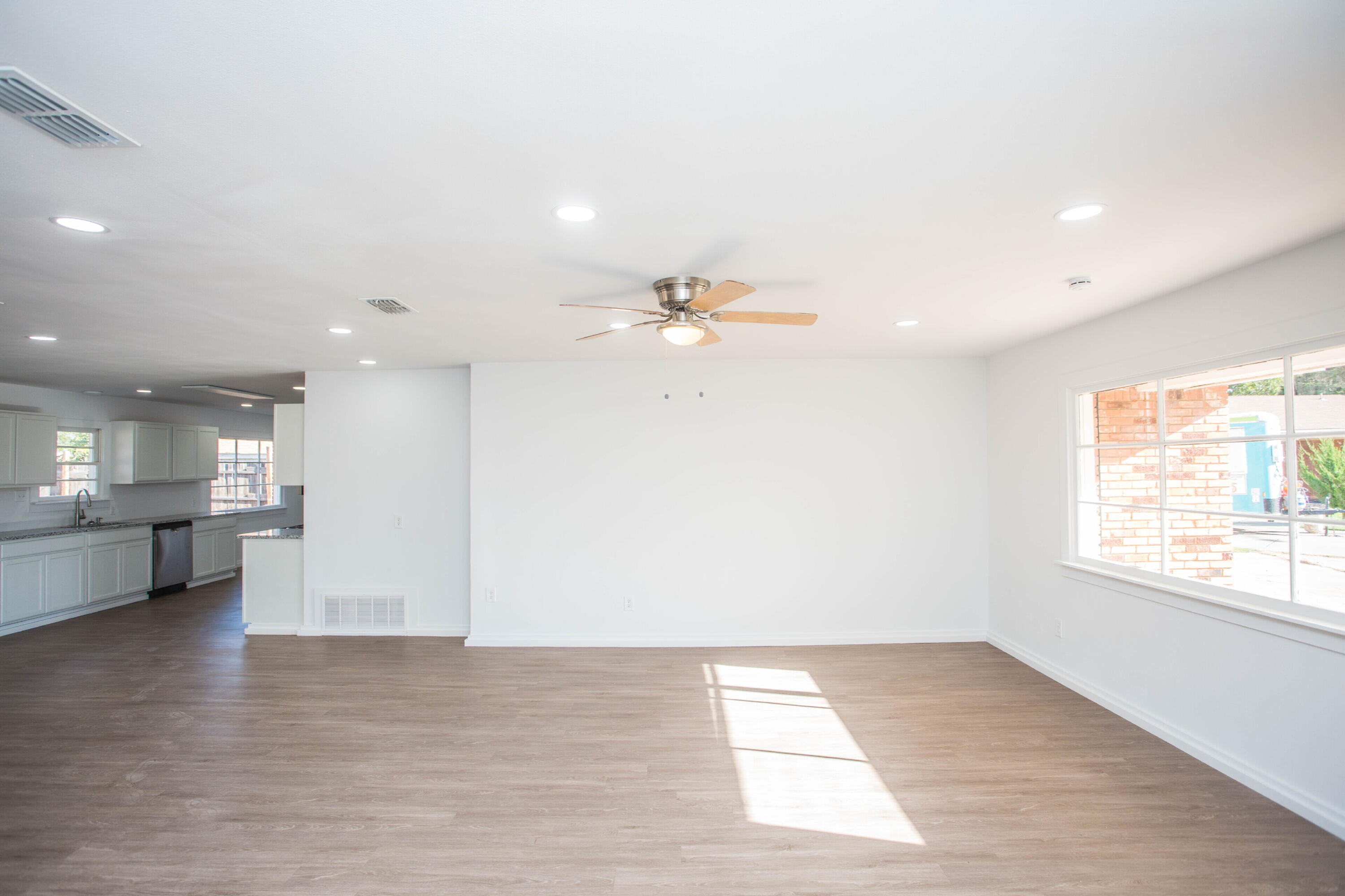 6004 Vernon Avenue Lubbock, TX 79412 - Photo 4 of 34 a view of empty room with kitchen and window