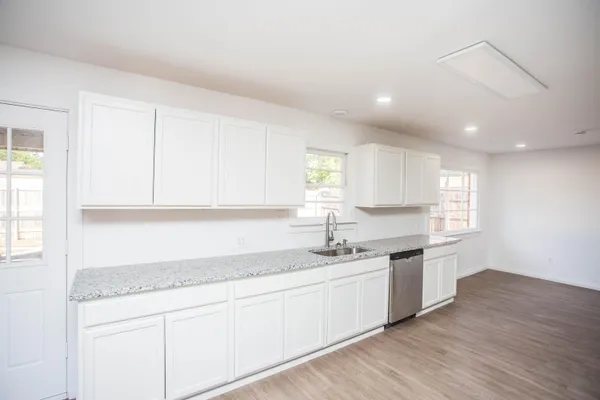 a kitchen with a sink cabinets and window