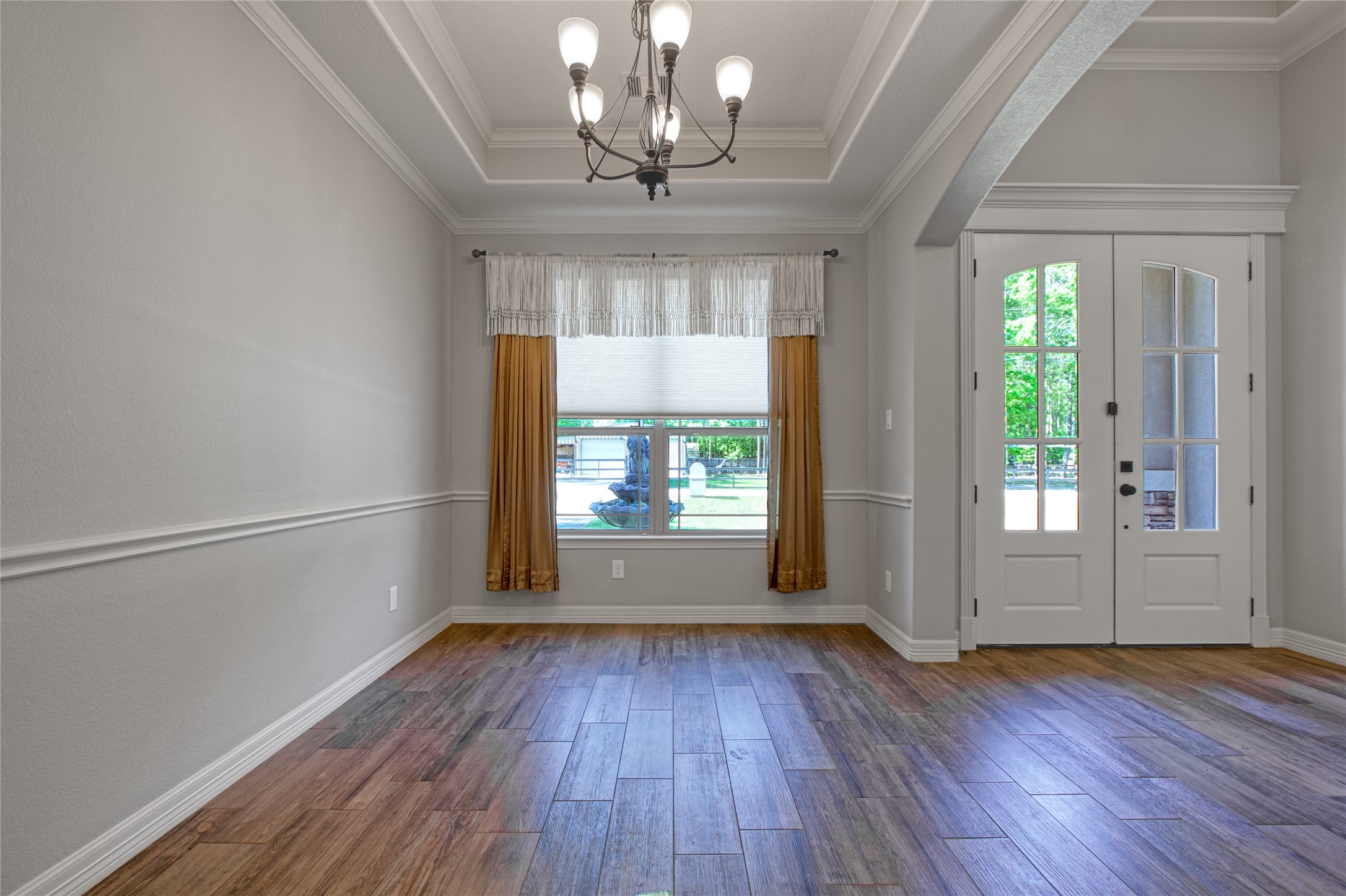 27684 Rio Blanco Drive Splendora, TX 77372 - Photo 6 of 31 an empty room with wooden floor chandelier and windows