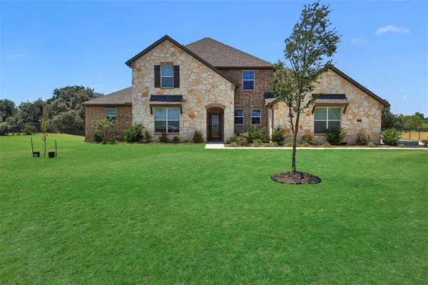 a front view of a house with a yard