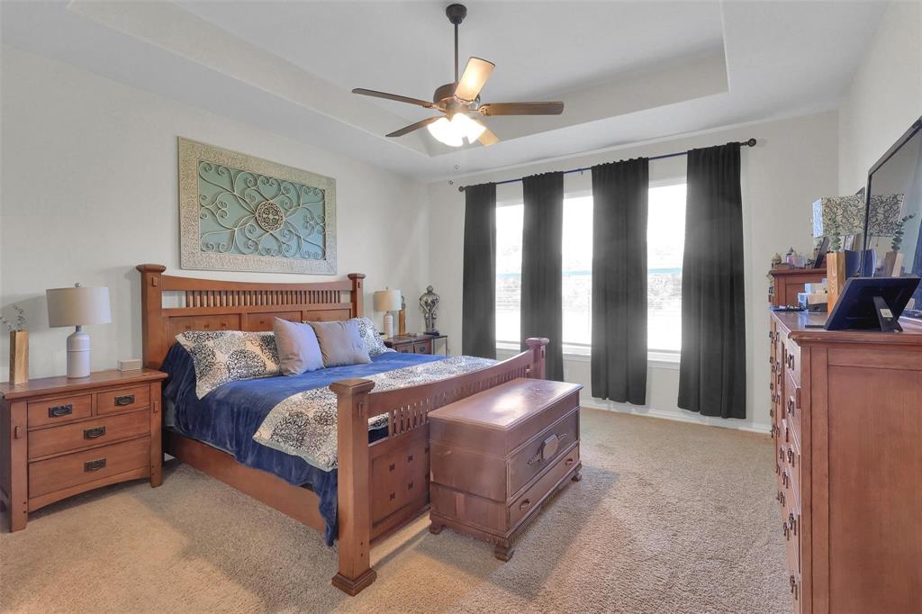 154 Chester Road Springtown, TX 76082 - Photo 11 of 40 a bed room with a bed and a window