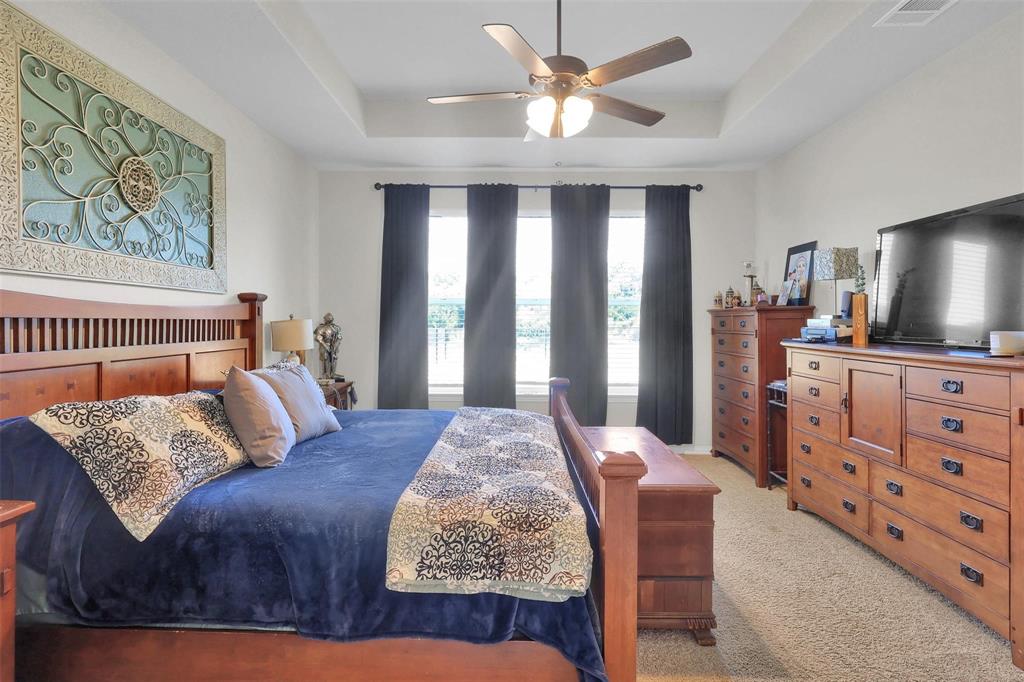 154 Chester Road Springtown, TX 76082 - Photo 12 of 40 a bedroom with a bed and a flat screen tv