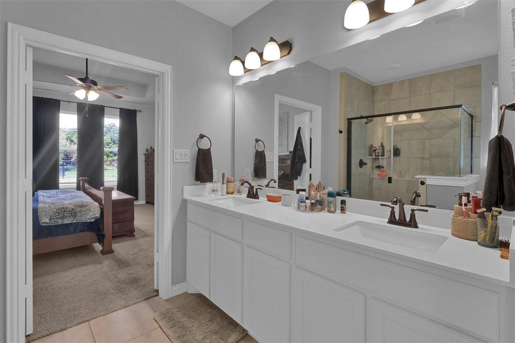 154 Chester Road Springtown, TX 76082 - Photo 14 of 40 a bathroom with a double vanity sink and a mirror