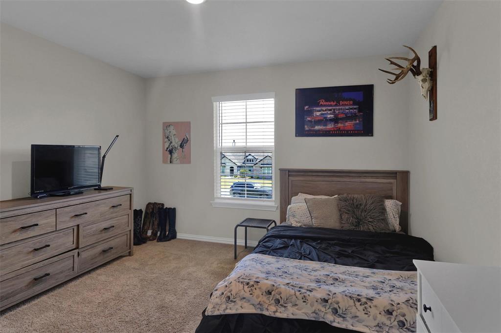 154 Chester Road Springtown, TX 76082 - Photo 26 of 40 a bedroom with a bed and window