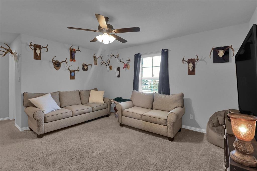 154 Chester Road Springtown, TX 76082 - Photo 29 of 40 a living room with furniture a ceiling fan and a window