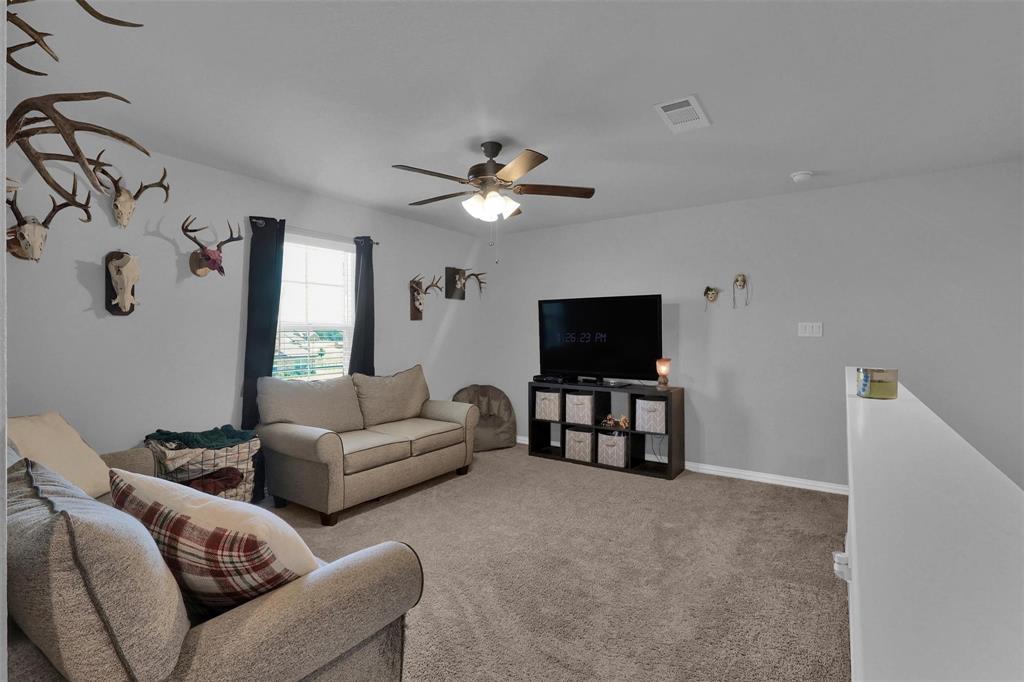 154 Chester Road Springtown, TX 76082 - Photo 30 of 40 a living room with furniture and a flat screen tv