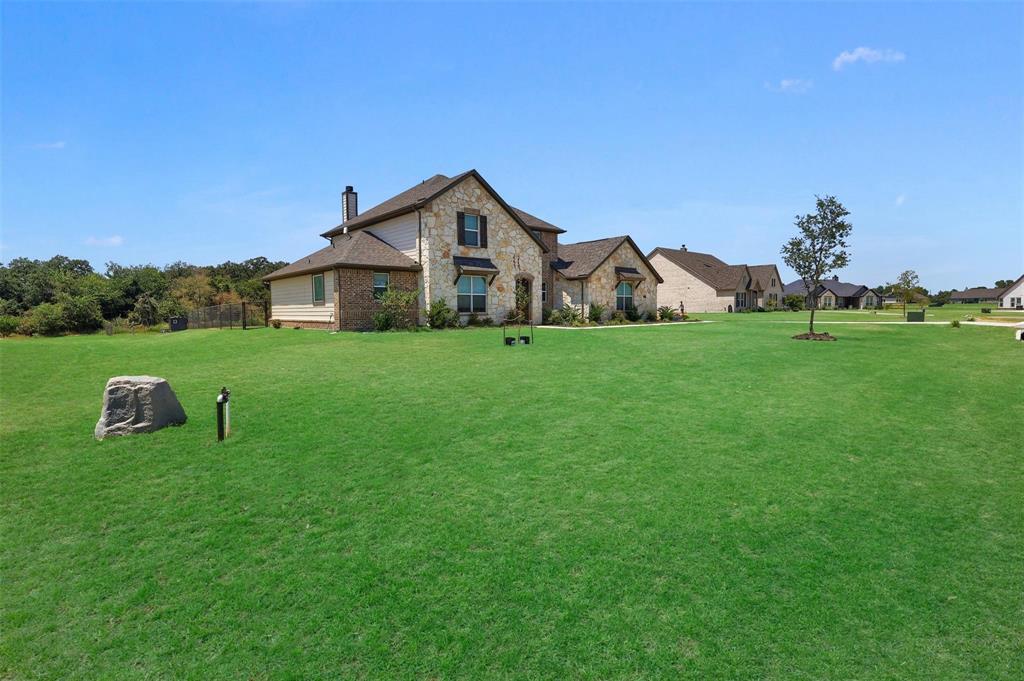 154 Chester Road Springtown, TX 76082 - Photo 3 of 40 a view of a house with a yard and sitting area