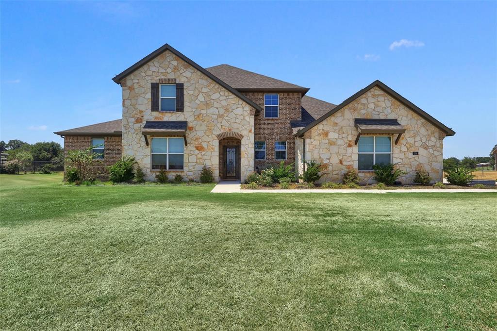 154 Chester Road Springtown, TX 76082 - Photo 37 of 40 a front view of house with yard and green space