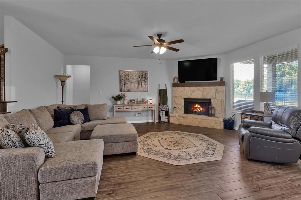 154 Chester Road Springtown, TX 76082 - Photo 5 of 40 a living room with furniture a flat screen tv and a fireplace