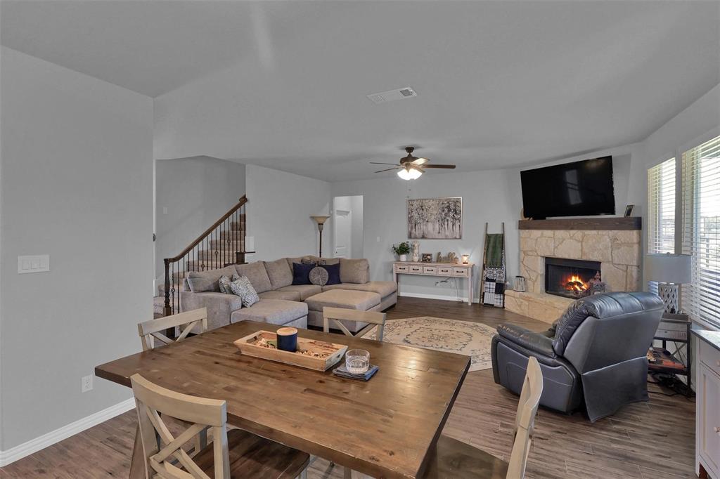 154 Chester Road Springtown, TX 76082 - Photo 6 of 40 a living room with furniture a fireplace and a flat screen tv