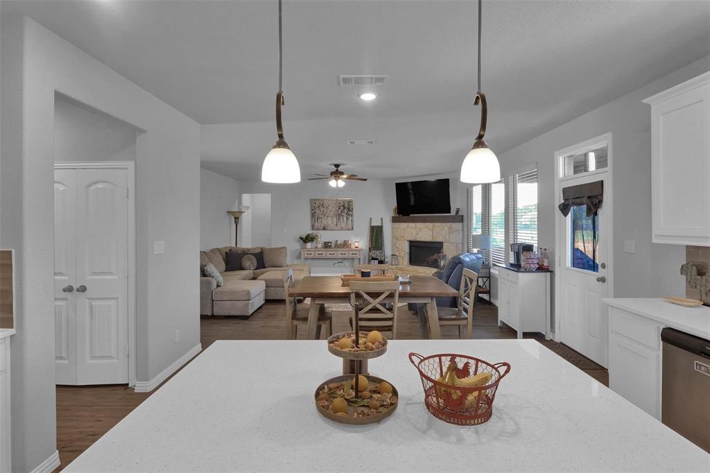 154 Chester Road Springtown, TX 76082 - Photo 10 of 40 a view of a dining room with furniture a chandelier and wooden floor