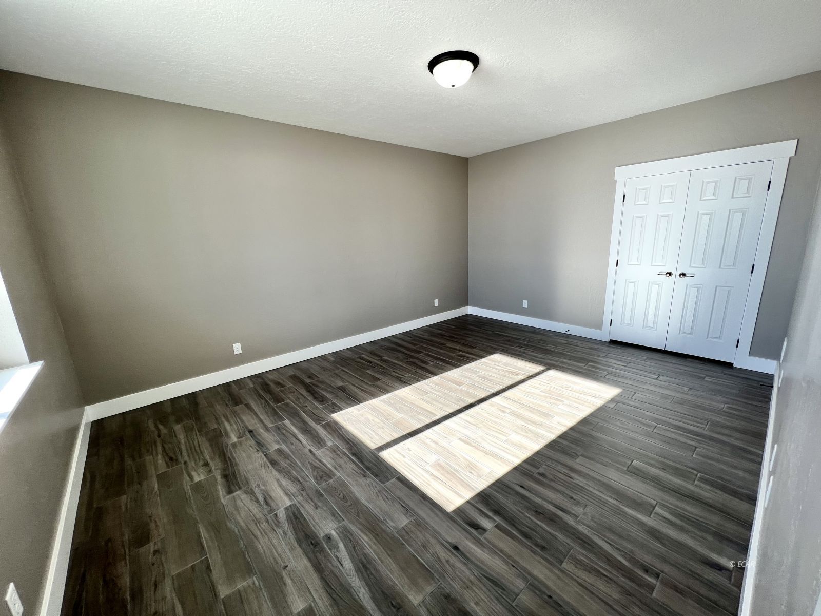 298 Ridgeway Drive Spring Creek, NV 89815 - Photo 14 of 45 an empty room with wooden floor