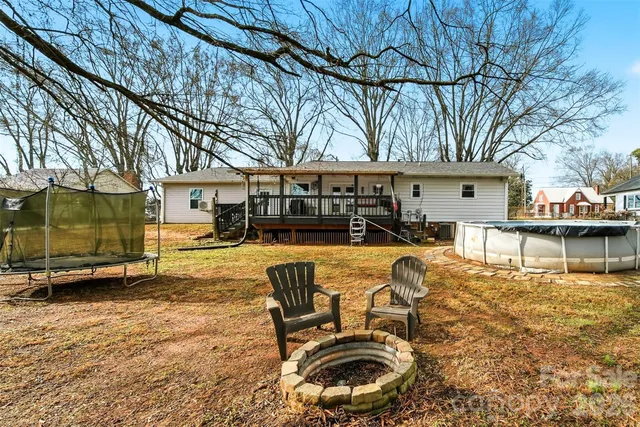 a swimming pool with outdoor seating and yard
