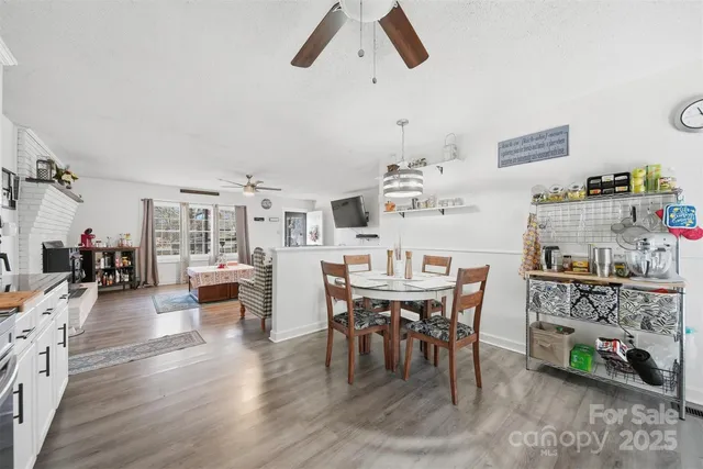 a dining room with furniture and a kitchen view