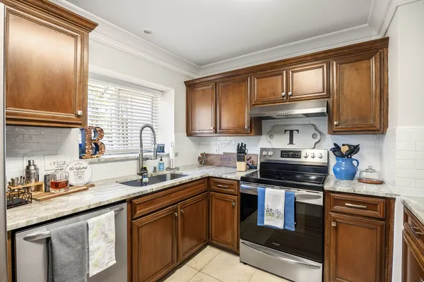 a kitchen with stainless steel appliances granite countertop a sink stove and cabinets