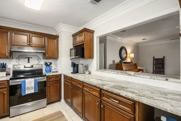 a kitchen with stainless steel appliances granite countertop a sink and a stove top oven
