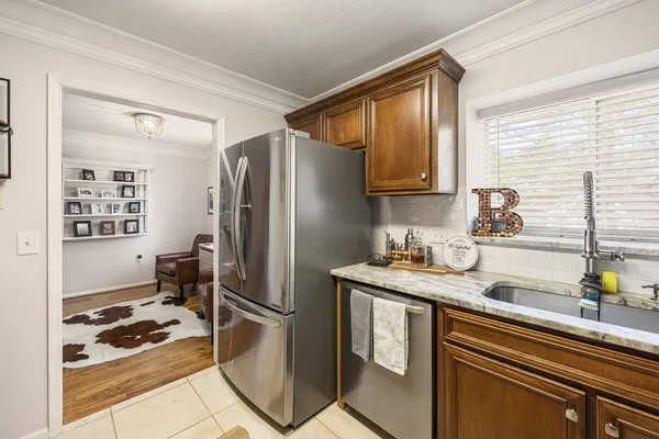 a kitchen with stainless steel appliances granite countertop a refrigerator and a sink
