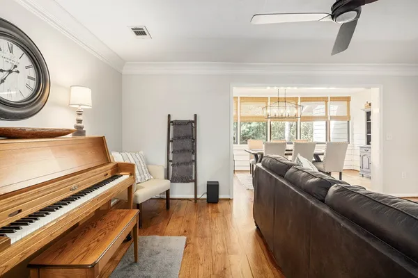 a living room with furniture and a floor to ceiling window