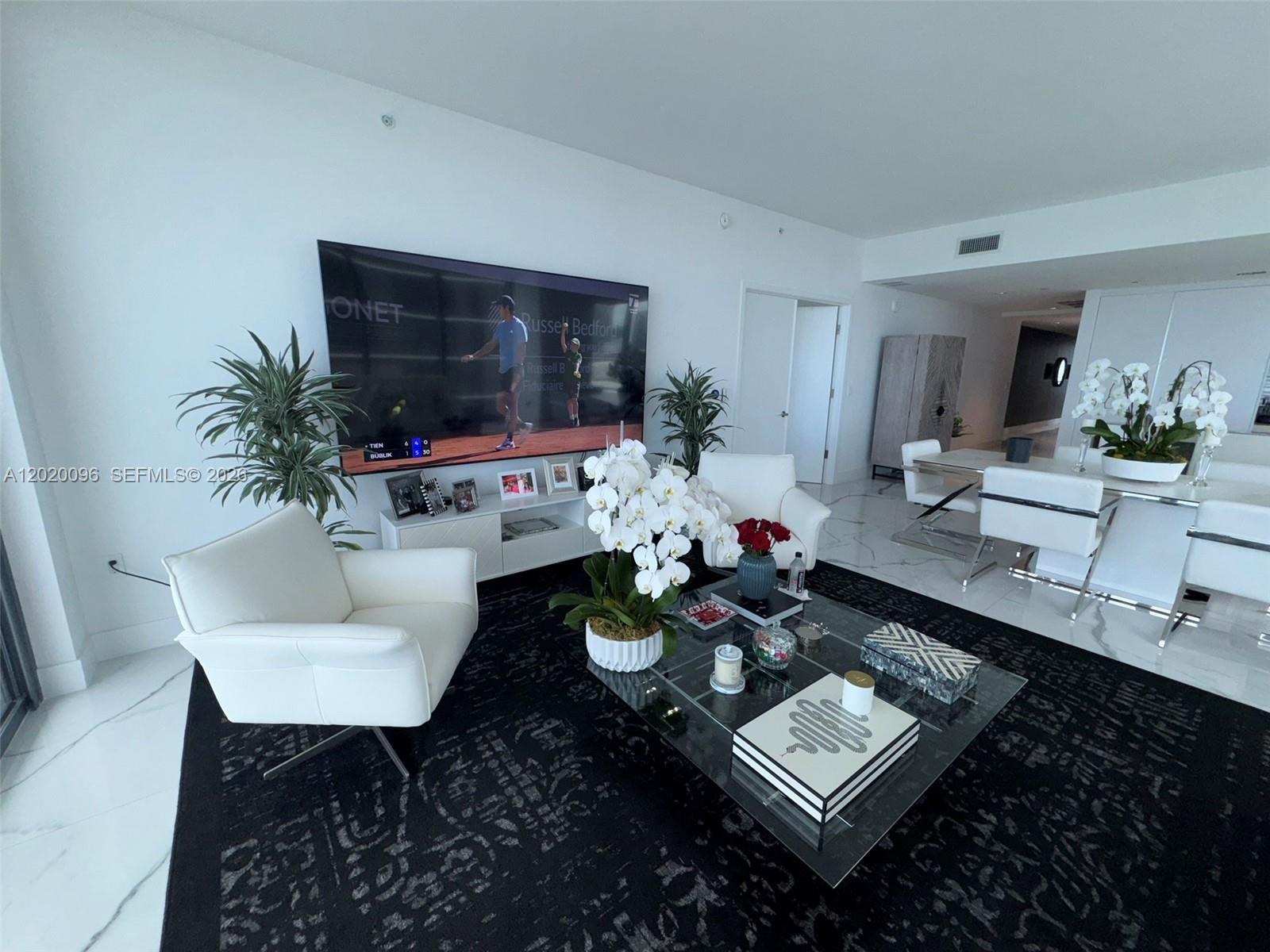 788 Northeast 23rd Street, Unit 1202 Miami, FL 33137 - Photo 8 of 64 a living room with furniture and a flat screen tv