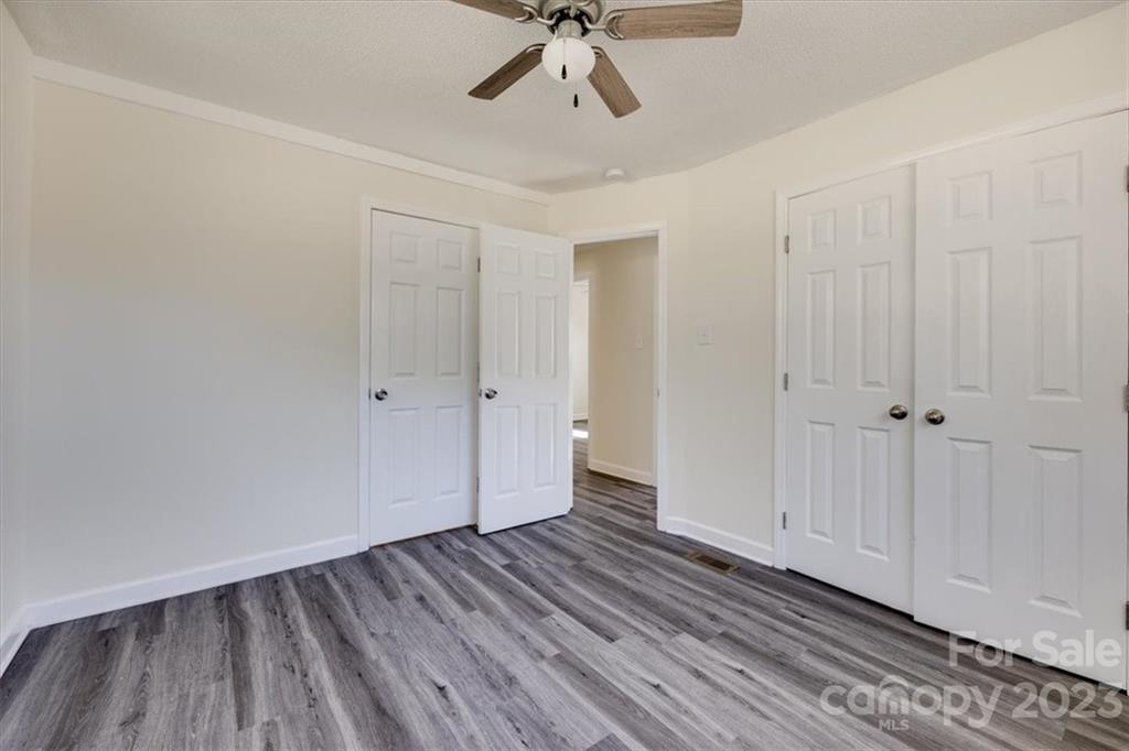 2887 State Rd S-29-330 Lancaster, SC 29720 - Photo 12 of 28 a view of a room with wooden floor closet and windows