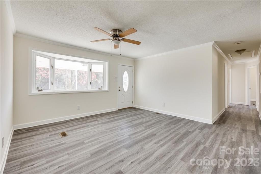 2887 State Rd S-29-330 Lancaster, SC 29720 - Photo 3 of 28 a view of an empty room with wooden floor and a window