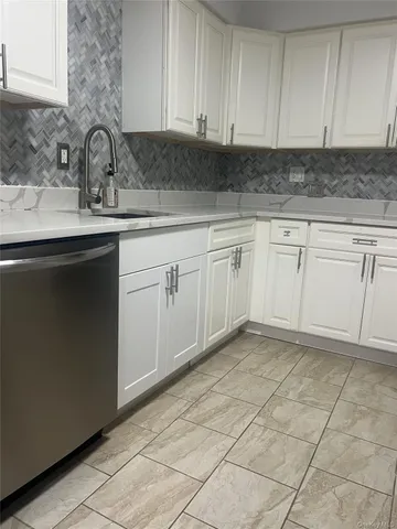 a kitchen with a sink and cabinets