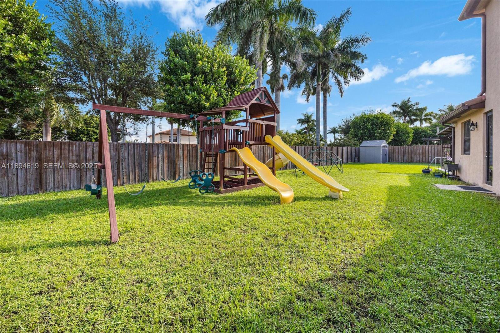 415 Southeast 34th Terrace Homestead, FL 33033 - Photo 42 of 60 a view of a backyard with a slide