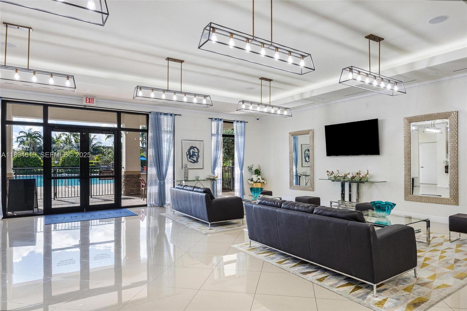 415 Southeast 34th Terrace Homestead, FL 33033 - Photo 56 of 60 a living room with furniture a flat screen tv and a chandelier