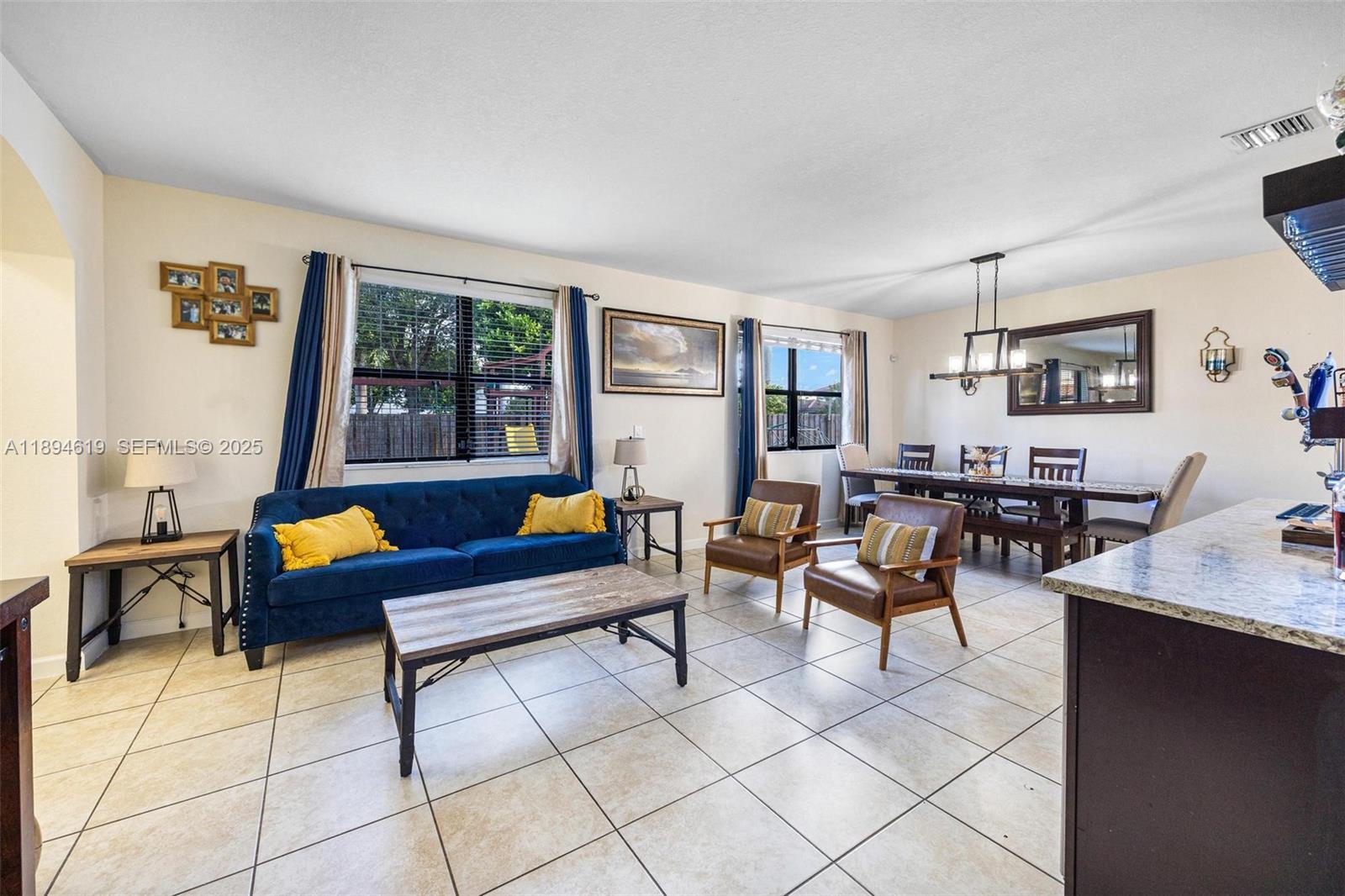 415 Southeast 34th Terrace Homestead, FL 33033 - Photo 6 of 60 a living room with furniture and a window