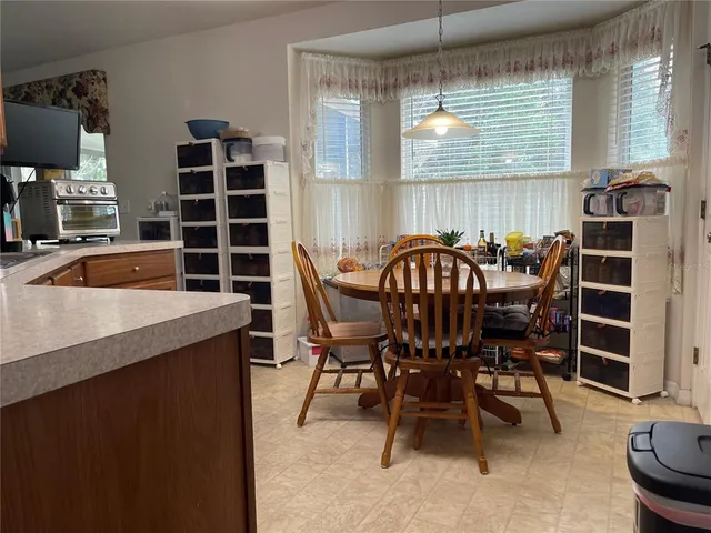 a view of a dining room with furniture and window