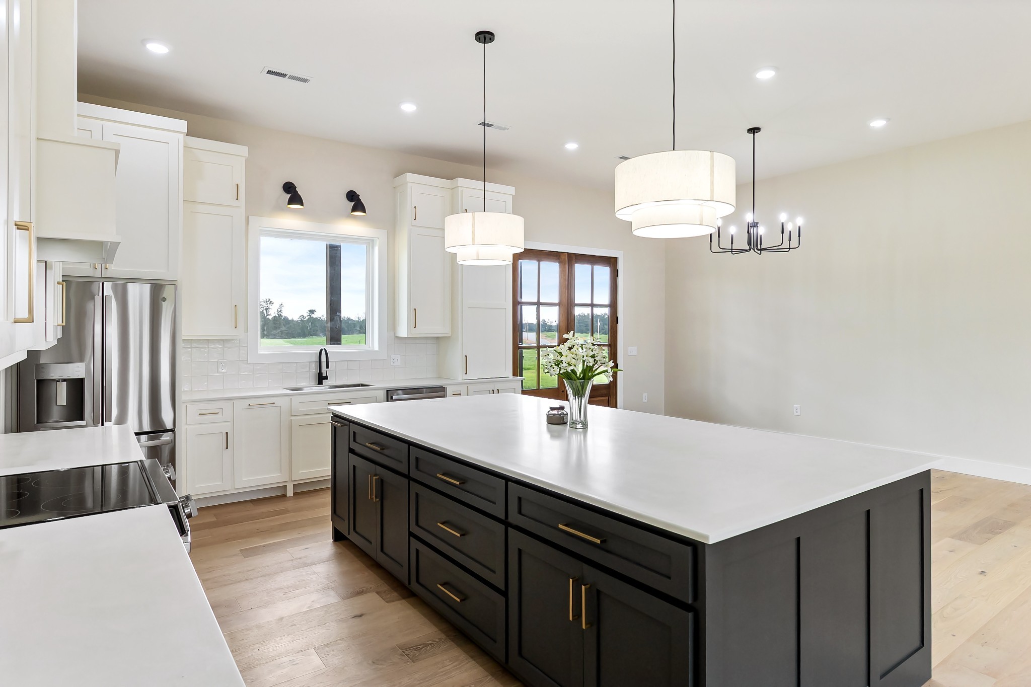 188 Beartown Road Loretto, TN 38469 - Photo 11 of 33 a large kitchen with a center island wooden floor stainless steel appliances and cabinets