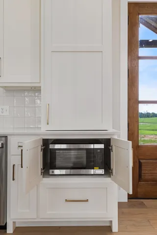 a kitchen with granite countertop a stove and a microwave