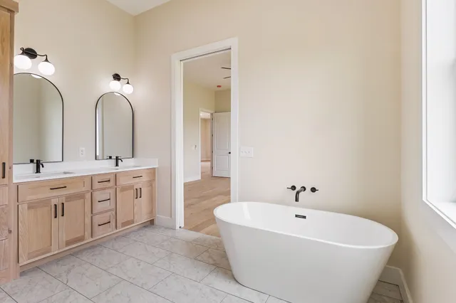 a spacious bathroom with a double vanity sink and a mirror