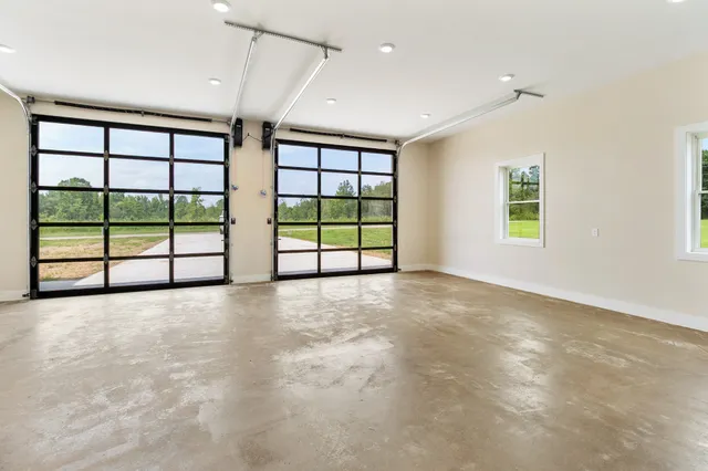 an empty room with windows and view of an empty room