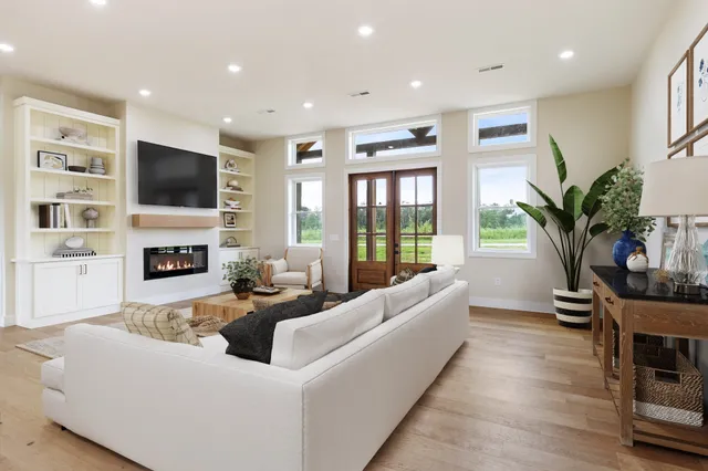 a living room with fireplace furniture and a flat screen tv